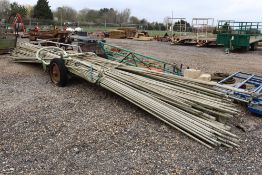 Irrigation pipe trailer. With a quantity of horticultural irrigation pipes.