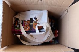 Box containing various pumpkin candles, carving sets, teeth, sticker books etc.
