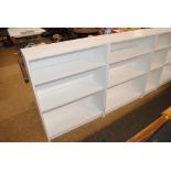 A pair of modern white open fronted bookcases with adjustable shelves