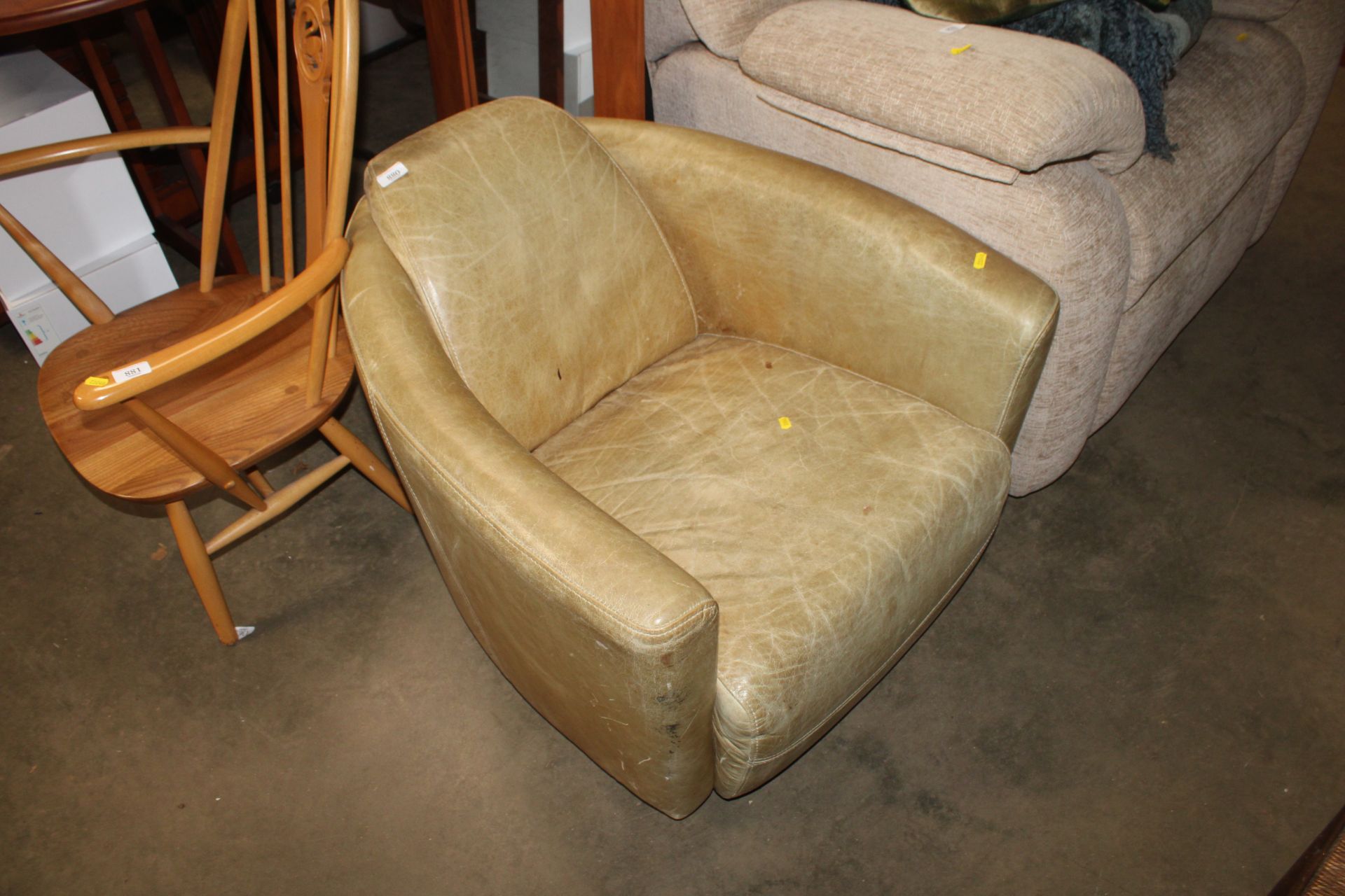 A leather upholstered rocket tub chair (lacking ba