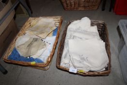 Two wicker baskets of various table linen