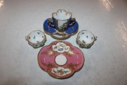 A Dresden style chocolate cup and saucer decorated with panels of courting couples, having