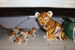 Four ornaments in the form of tigers to include US