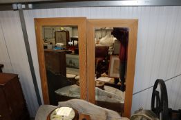 Two modern oak framed wall mirrors
