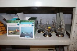Four models in the form of planes containing glass