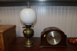 An oak cased three hole mantel clock and a brass o