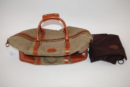 A Mulberry holdall with lock and dust bag