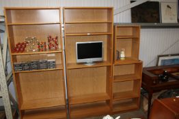 An oak effect open fronted bookcase fitted with adjustable shelves