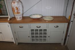 A modern oak topped sideboard fitted three drawer