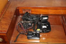 An Olympus Trip AF 35 camera, a Fuji camera and a