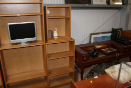 Two oak effect open fronted bookcases fitted with