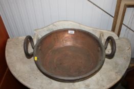 A copper twin handled preserve pan