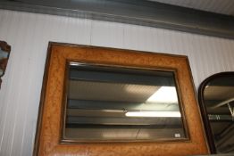 A gilt and floral decorated wall mirror
