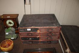 A vintage table top nest of filing drawers