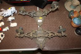 A pair of brass twin-branch folding wall lights