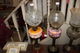 A double burner table oil lamp with opaque glass reservoir and brass column