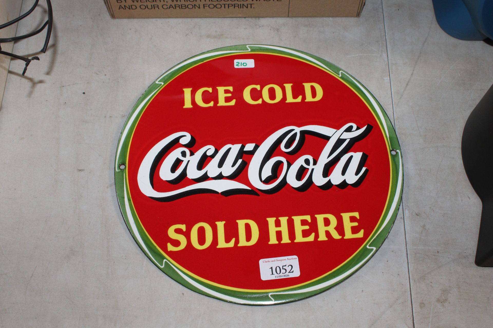 A reproduction Coca-Cola advertising sign (210)