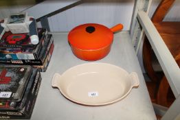 A Le Creuset twin handled cooking dish together wi