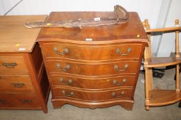 A reproduction mahogany serpentine fronted chest,