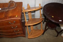 A light Ercol corner shelf