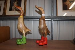 Two decorated wooden duck ornaments with coloured