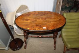 A Victorian burr walnut inlaid oval centre table raised on stretcher base