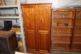 A modern pine two door wardrobe