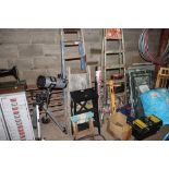 A folding stool and three wooden step ladders