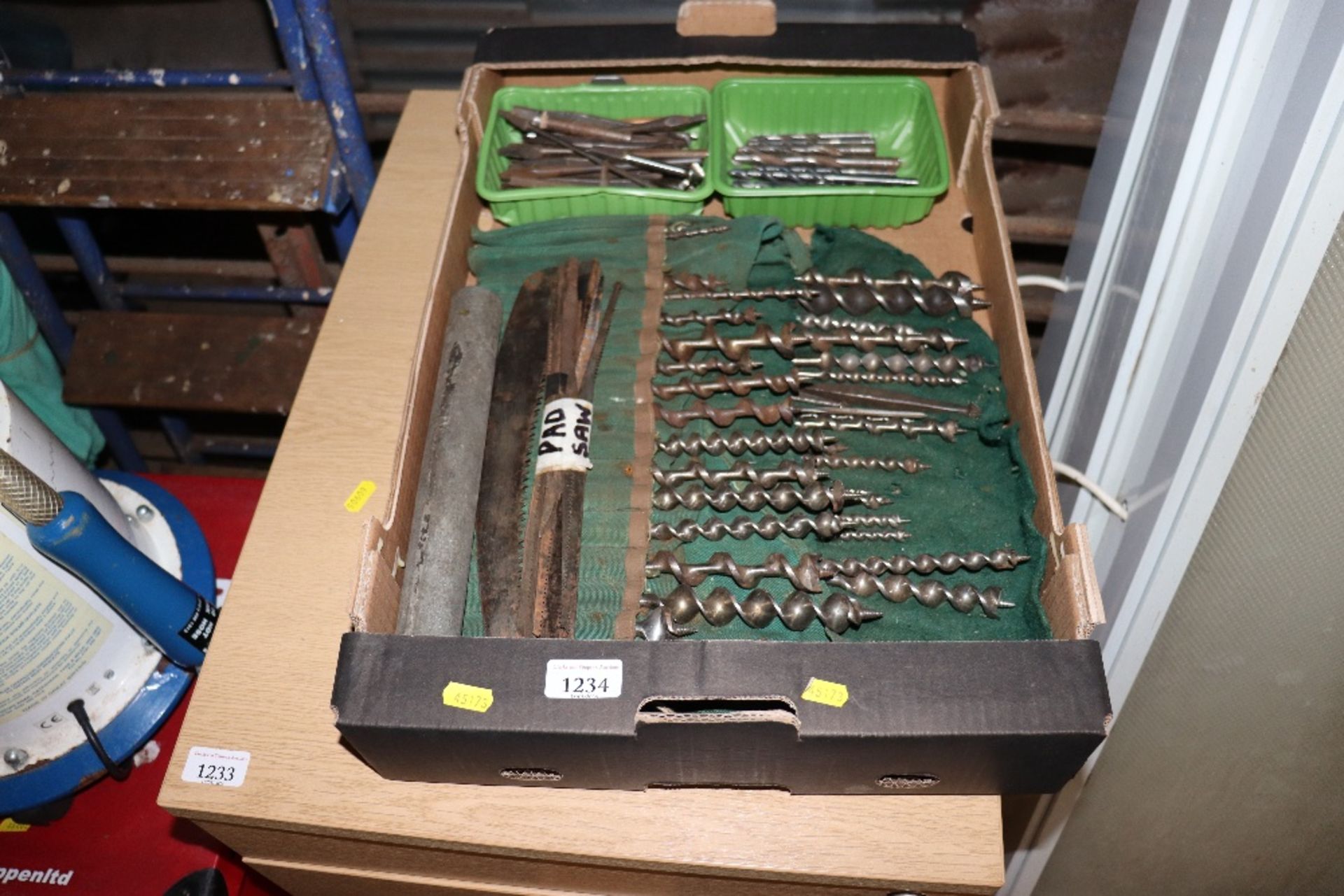 A box containing drill bits; auger bits and saw bl