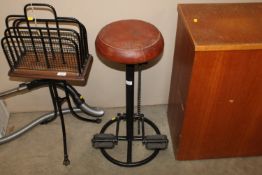 A leatherette topped bar stool in the form of a bi