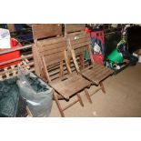 A set of four wooden folding garden chairs