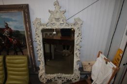 An ornate framed and bevel edged wall mirror