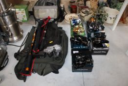 A quantity of various fishing reels; two telescopi