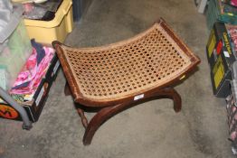 A curved string topped stool