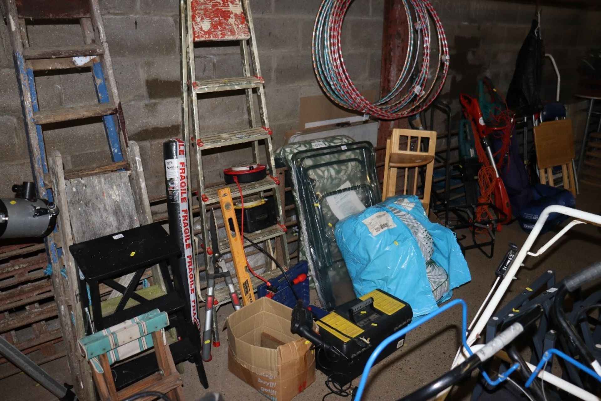An aluminium step ladder; a roll of weed control f