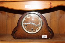 An oak cased three hole mantel clock
