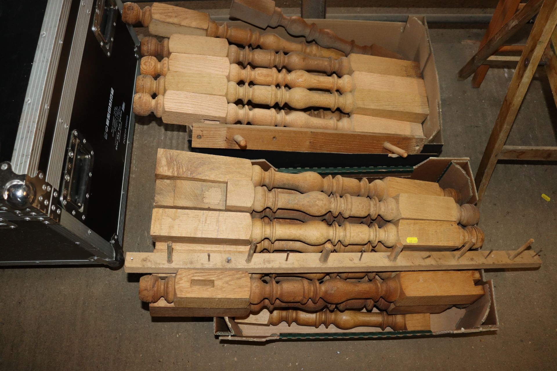 Two boxes of turned wooden balustrades