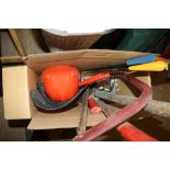 A box containing hand saws, a bow saw, an axe, saf