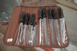 9 Pce knife set in bag. This item can only be purchased by someone over the age of 18 and ID