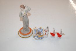 Three Russian figurines; a Capo di Monte figurine and a collection of dolls teaware