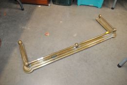 A Victorian brass fender
