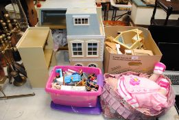 A dolls house, various furniture and a doll a cot