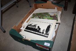 A box containing various illustrated ephemera
