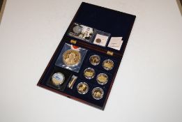 A case containing six WWI Centenary coin sets, a commemorative Queens Coronation coin, a Canadian