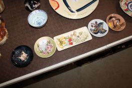Four Moorcroft dishes with adhesive plate hangers and an oblong Moorcroft dish