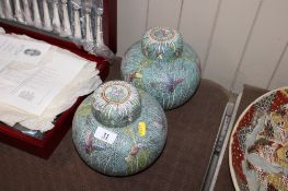 A pair of Oriental ginger jars and covers with floral and butterfly decoration