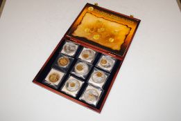 A case containing The Royal Shield of Arms coin collection with certificate