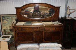 An oak mirror back sideboard fitted two drawers