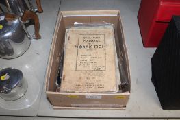 A box containing vintage car manuals