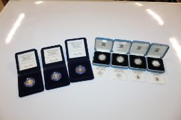 Three royal Mint silver proof 1982 20pence pieces, 10gms each; and four Royal Mint silver proof £1